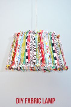 a lamp shade made out of fabric hanging from a hook with the words diy fabric lamp on it