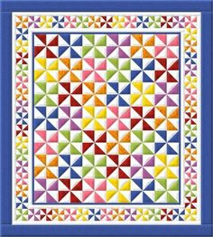 a colorful quilt with triangles on it