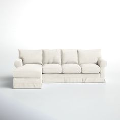 a white couch sitting on top of a white floor