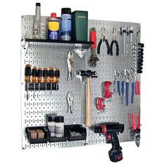 the pegboard is organized with tools and other things to use for repair on it