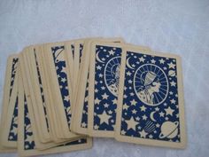 four playing cards with stars and planets on them