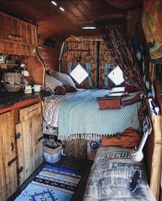 a bed sitting in the middle of a bedroom next to a wooden cabinet and counter