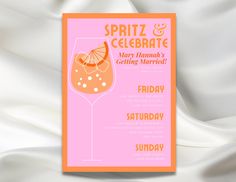 an orange and pink party card with a cocktail glass on the front, against a white satin background