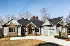 a large house with two car garages on the front and one story above it