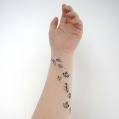 a woman's arm with a flower tattoo on it