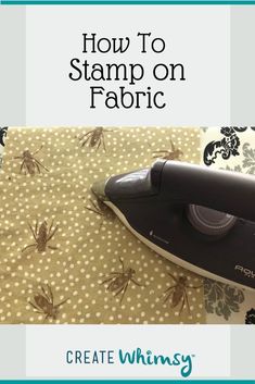 a steam iron sitting on top of a table next to a fabric covered wallpaper