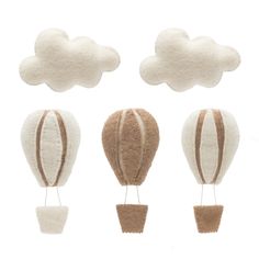 three hot air balloons in the shape of clouds