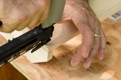 a man is using a planer to cut planks on a wooden table top