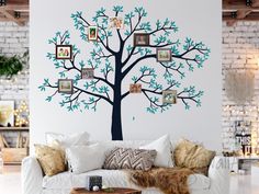 a living room with a couch and tree wall decal