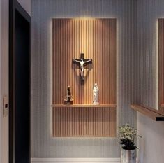 a cross and crucifix are on the wall in this small room with wood paneling