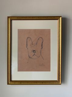 a drawing of a dog is hanging on the wall