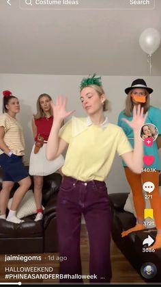 a group of women standing around each other in front of a camera with their hands up