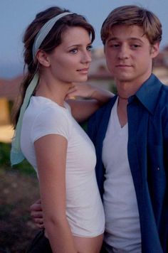 a young man and woman standing next to each other in front of a collage