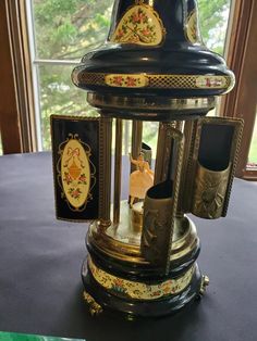 an ornate clock on display in front of a window