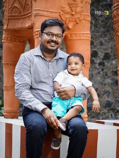 a man holding a small child in his lap