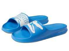 Lacoste Croco 2.0 222 1 CMA Slide - Men's Shoes : Light Blue/White : Lacoste brings you the comfy Croco2.0 222 2 CMA Slide Sandals, perfect to go with your poolside outfit. EVA upper. EVA lining and insole. Slip-on style. OrthoLite footbed. Signature brand detailing on the upper. EVA outsole. Imported. Casual Blue Sandals For Poolside, Casual Slip-resistant Sport Sandals, Casual Blue Sport Sandals For Swimming, Casual Cushioned Sandals For Poolside, Casual Cushioned Flip Flops For Poolside, Casual Pool Slides For Spring, Casual Synthetic Sandals For Pool, Casual Slip-on Flip Flops For Pool, Casual Slip-on Pool Flip Flops