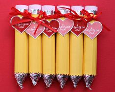 valentine's day pencils with hearts on them are lined up against a red background