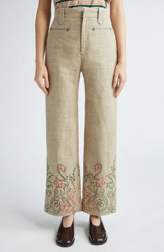 A Victorian-era travel bag provided the trumpetflower embroidery pattern growing from the hems on these pants cut from richly textured, breathable linen. 29" inseam; 20 1/2" leg opening; 12" front rise; 15 1/2" back rise (size 27) Zip fly with hook-and-bar closure Front welt pockets Lined 100% linen Dry clean Imported Designer Clothing Embroidery On Pants Indian, Embroidery On Linen Pants, Spring Wide Leg Bottoms With Resham Embroidery, Embroidered Wide-leg Beige Pants, Embroidered Wide Leg Beige Pants, Embroidered Beige Wide Leg Pants, Spring Straight Pants With Resham Embroidery, Straight Pants With Resham Embroidery For Spring, Summer Straight Pants With Embroidered Border