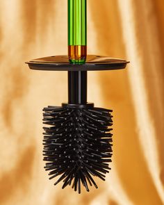 a hairbrush holder holding a green and black brush