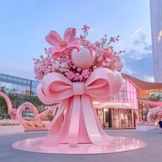 a large pink flower arrangement in front of a building