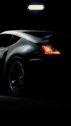 a black sports car parked in the dark