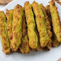 some fried food is on a white plate and ready to be eaten with chopsticks