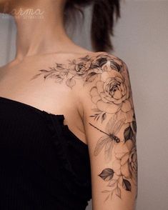 a woman with a flower tattoo on her shoulder