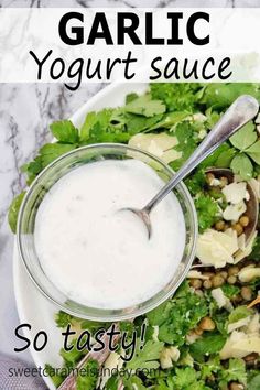 a bowl filled with salad and dressing next to the words, garlic yogurt sauce so tasty