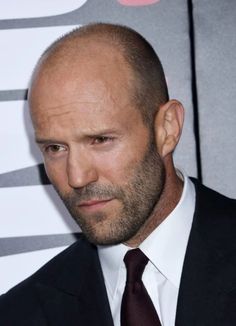 To get Jason Statham’s style bald men look, you can shave your head or try a short stubble look. However, you’ll need to grow out your stubble just slightly and maintain with a longer guard on your electric beard trimmer to get Statham’s beard. Along with his incredible acting skills, he has also never had any problems with women, according to his fiancee Rosie Huntington-Whiteley. Balding Hairstyles, Professional Beard Styles, Bald Celebrities, Buzzcut Men, Beard Styles Bald, Bald Hairstyles