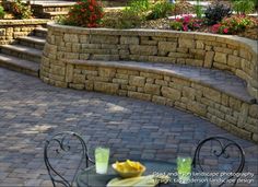 an outdoor patio with stone steps and seating area