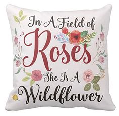 a pillow that says, in a field of roses she is a wildflower