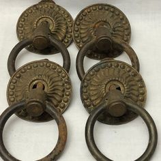 four antique brass door knobs with circular handles