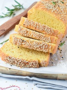 sliced loaf of sesame seed bread on a cutting board