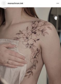 a woman with a flower tattoo on her chest