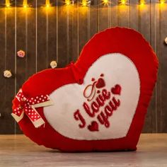 a heart shaped pillow that says i love you