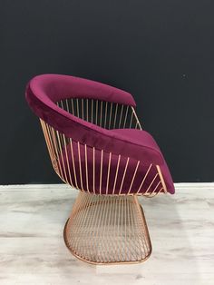 a purple chair sitting on top of a wooden table