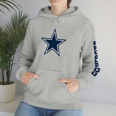 Show off your Dallas Cowboys Pride!!  This unisex heavy blend hooded sweatshirt is relaxation itself. Made with a thick blend of cotton and polyester, it feels plush, soft and warm, a perfect choice for any cold day. In the front, the spacious kangaroo pocket adds daily practicality while the hood's drawstring is the same color as the base sweater for extra style points. .: 50% cotton, 50% polyester .: Medium-heavy fabric (8.0 oz/yd² (271 g/m .: Classic fit .: Tear-away label .: Runs true to size Winter Fan Apparel Hoodie In Athletic Heather, Cotton Long-sleeve Hoodie With Team Name, Winter Fan Apparel Hoodie, Winter Fan Gear Hoodie With Long Sleeves, Winter Fan Gear Hoodie, Winter Fan Merchandise Hoodie, Winter Fleece Sweats For Sports Events, Winter Fan Merchandise Hoodie With Team Spirit, Winter Fan Merchandise Cotton Hoodie