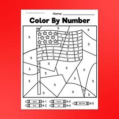 the color by number american flag is shown on a red background with markers and crayons