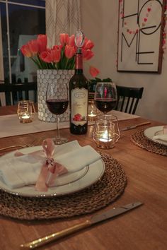 a table set for two with wine and candles