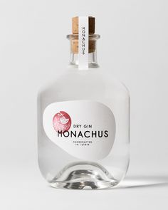 a glass bottle with a corked top and label that says dry gin monachuus