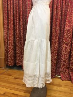 "1900s, 32\" waist, white lightweight linen petticoat, with wide peplum at lower half of petticoat, with flounce of hand crochet lace. Petticoat is fastened at back of waist band with white round buttons. Measurements: waist 32\" Mid section 50\" Waist to hem 36\" Width of flounce at bottom 90\" Condition excellent" Jessica Brown, Round Button, Cheongsam Dress, Silk Crepe, Circle Skirt, Burgundy Color, Cheongsam, Petticoat, Waist Band