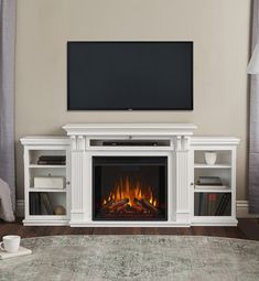 a living room with a fireplace and entertainment center