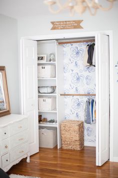 a white closet with shelves and baskets in it