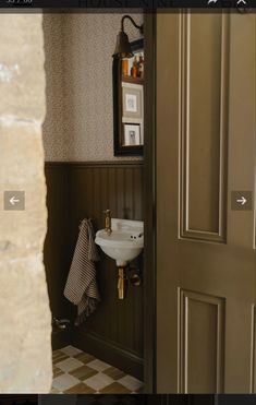 an open door with a sink and towel hanging on the wall next to it in a bathroom