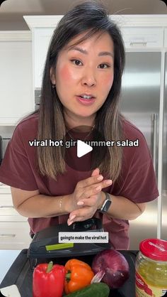 a woman standing in front of a counter filled with vegetables and condiments on it