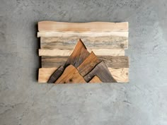 a piece of wood that has been made to look like mountains