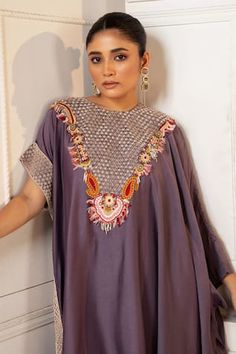 Purple silk asymmetric kaftan with floral pearls, beads, thread work and zardosi embroidered yoke. Paired with coordinating solid straight pant. - Aza Fashions Anarkali Hand Embellished Kaftan For Festive Occasions, Festive Anarkali Hand Embellished Kaftan, Festive Hand Embellished Kaftan With Traditional Drape, Festive Hand Embellished Anarkali Kaftan, Festive Hand Embellished Traditional Kaftan, Festive Hand-embellished Traditional Kaftan, Embellished Kaftan With Traditional Drape For Reception, Traditional Embellished Kaftan For Reception, Traditional Designer Kaftan Hand Embellished