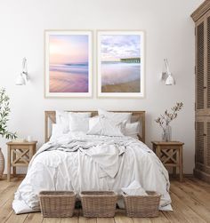 a bed with white sheets and pillows in a room next to two baskets on the floor