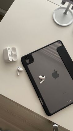 an ipad and ear buds on a table