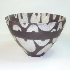 a black and white bowl sitting on top of a table